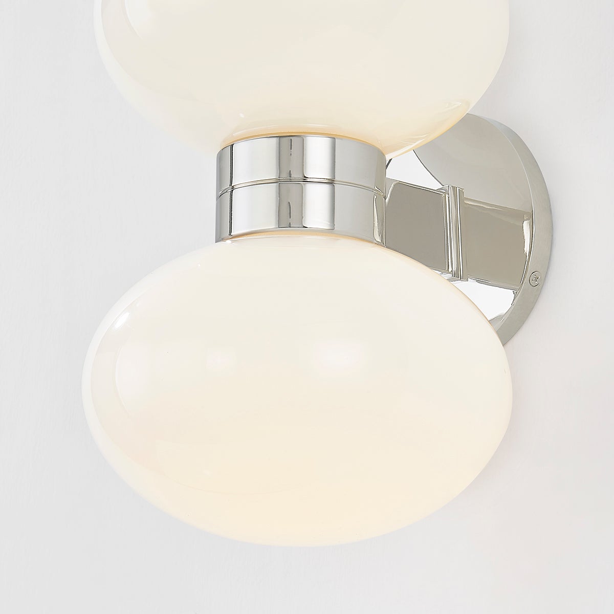 Close-up of the Otsego Wall Sconce in polished nickel showing the arm curve and shade silhouette.