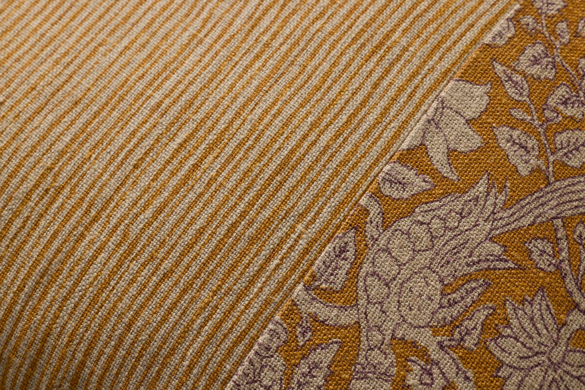 Mustard Pillow shown from a different angle to reveal its pattern.