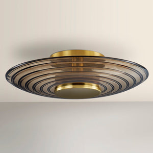 Griston Wall Sconce 12" x 12" in aged brass shown from the front to reveal the arm curve and shade silhouette.