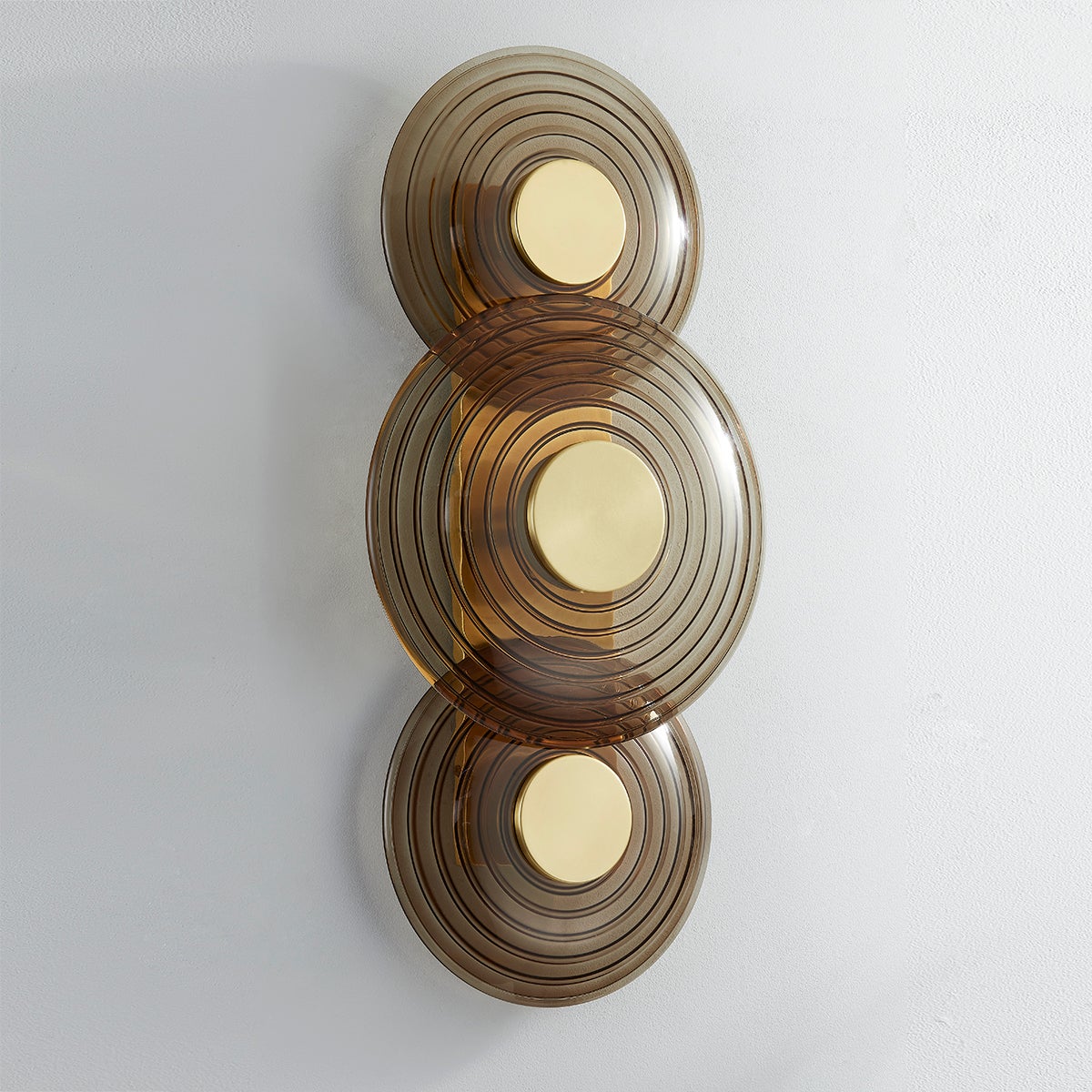 Close-up of the Griston Wall Sconce 12" x 25.75" in aged brass showing the arm curve and shade silhouette.