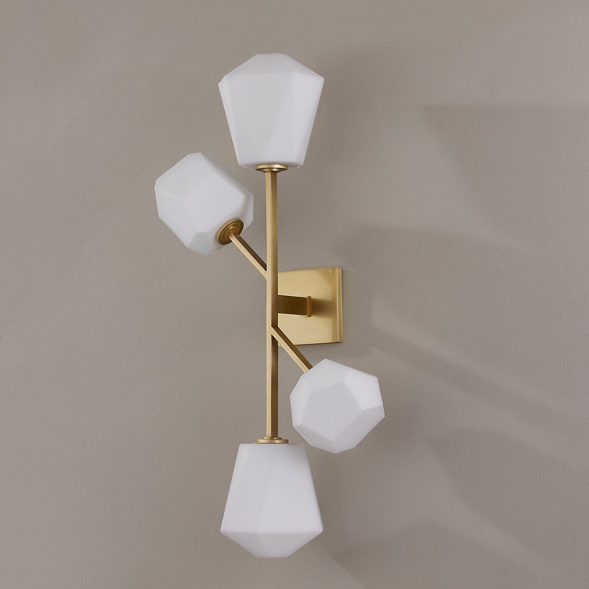 Close-up of the Tring Wall Sconce in aged brass showing the arm curve and shade silhouette.