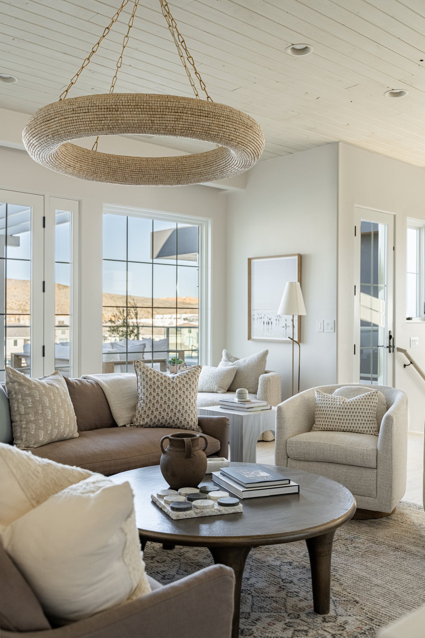 Lure Chandelier 50" styled in an elegant dining room for warm, layered light at Laurie Yapp Home.