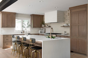 Pomfret Pendant in aged brass styled in an elegant dining room for warm, layered light at Laurie Yapp Home.