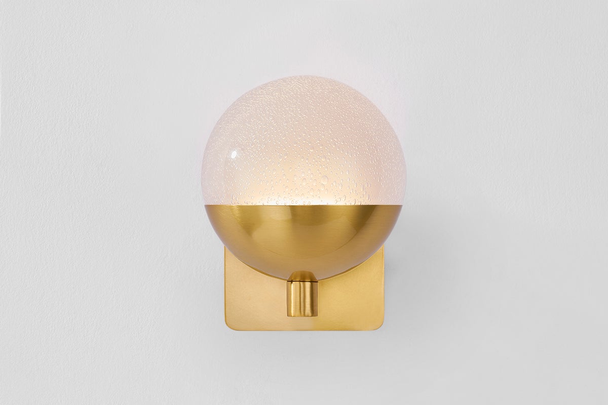 Rochford Wall Sconce in aged brass shown from the front to reveal the arm curve and shade silhouette.