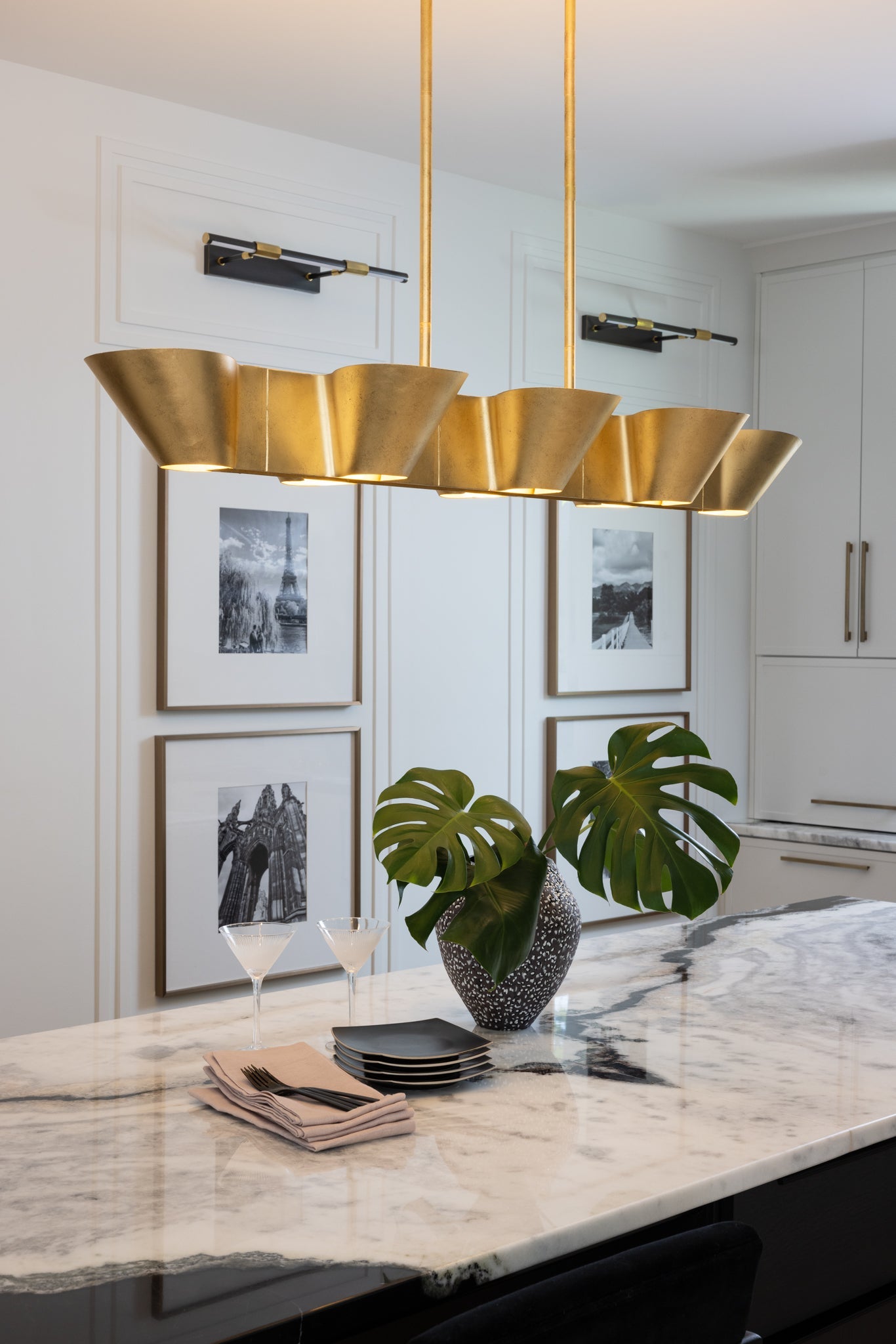 Reeve Linear in aged brass styled in a dining room for warm, layered light at Laurie Yapp Home.