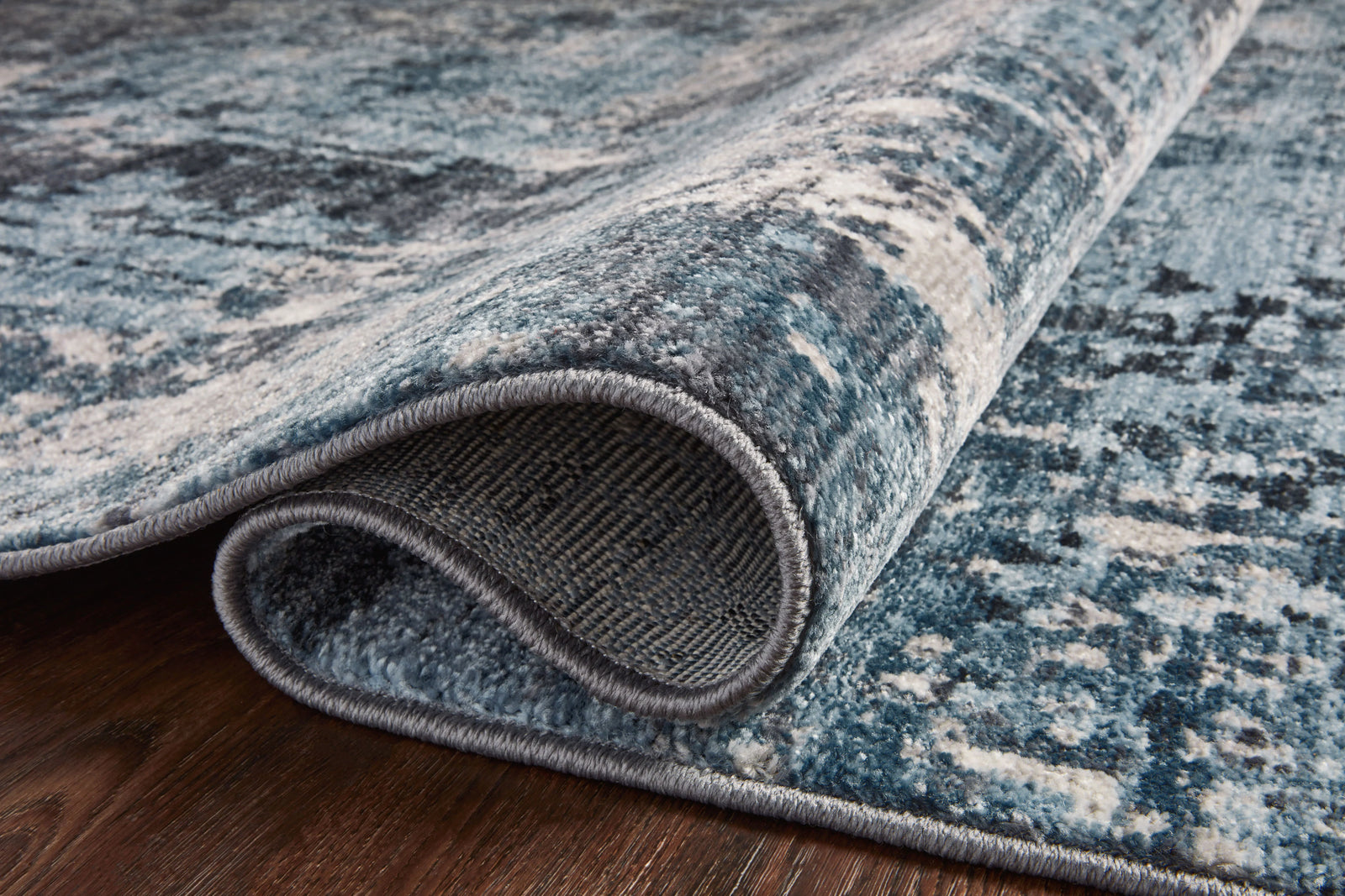 Samra Charcoal and Sky area rug by Loloi styled in a room at Laurie Yapp Home.