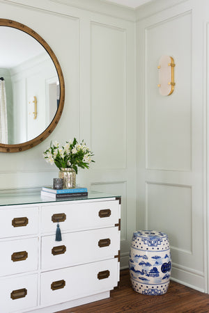 Skylar Wall Sconce 5.75" x 13.75" in aged brass styled in a curated living room for warm, layered light at Laurie Yapp Home.