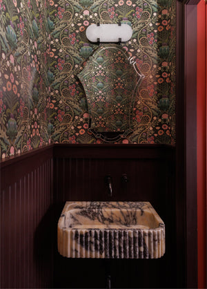Skylar Wall Sconce 5.75" x 13.75" in bronze styled in a modern bathroom for warm, layered light at Laurie Yapp Home.