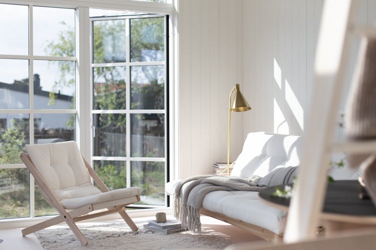 Stanton Floor Lamp in aged brass styled in a bedroom for warm, layered light at Laurie Yapp Home.