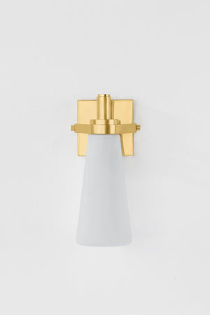 Trude Wall Sconce in aged brass shown from the front to reveal the arm curve and shade silhouette.