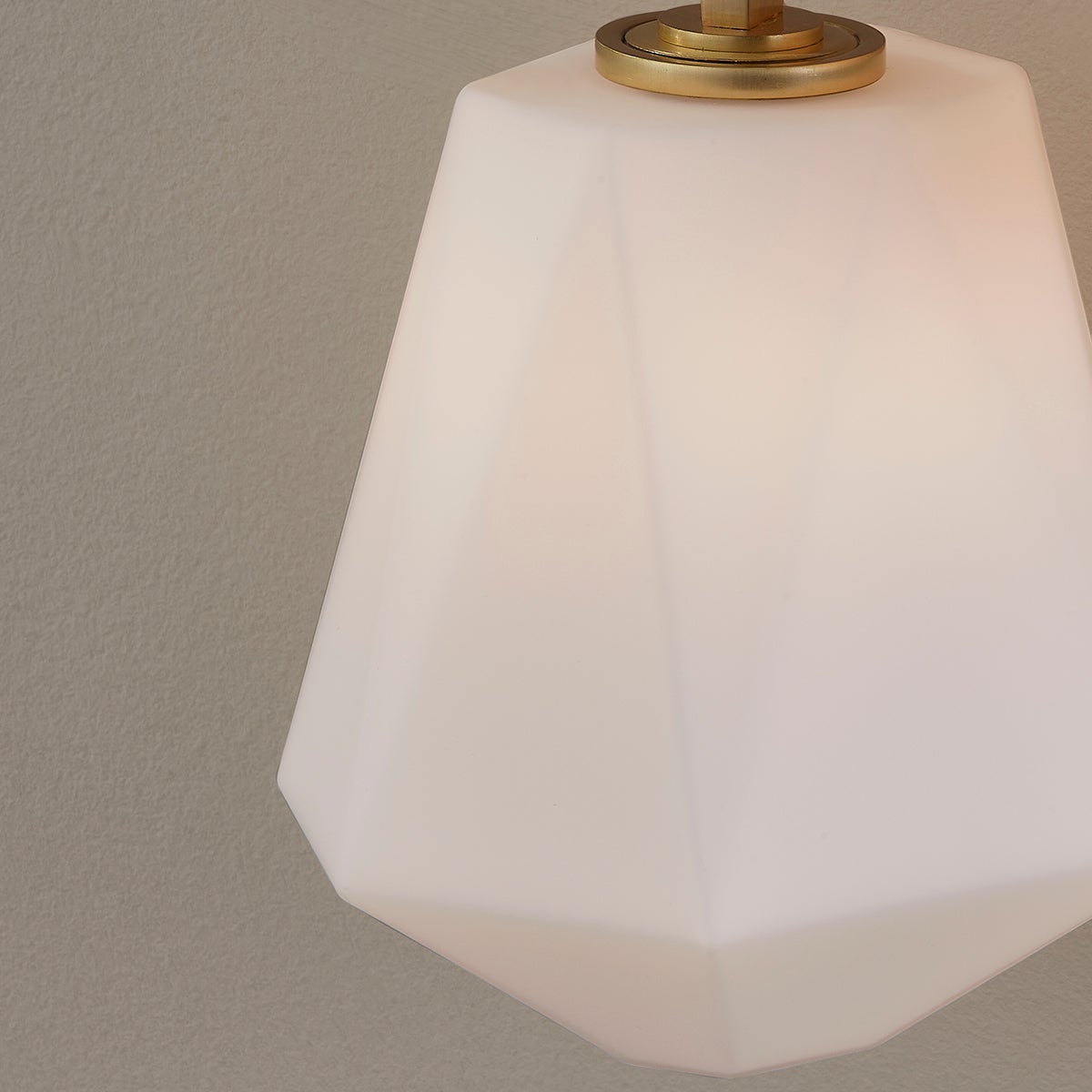 Tring Wall Sconce in aged brass shown from the front to reveal the arm curve and shade silhouette.