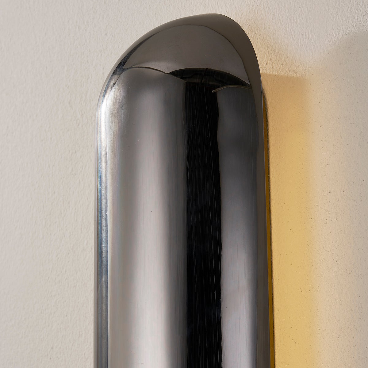Close-up of the Wheeler Wall Sconce showing the arm curve and shade silhouette.