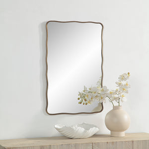 Basel Wall Mirror displayed on a wall with a vase of flowers and decorative bowl.