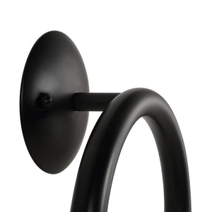 Close-up of Santo wall sconce showing black mount and curved arm