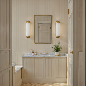 Amici wall sconce in a modern bathroom with beige paneling and marble countertop