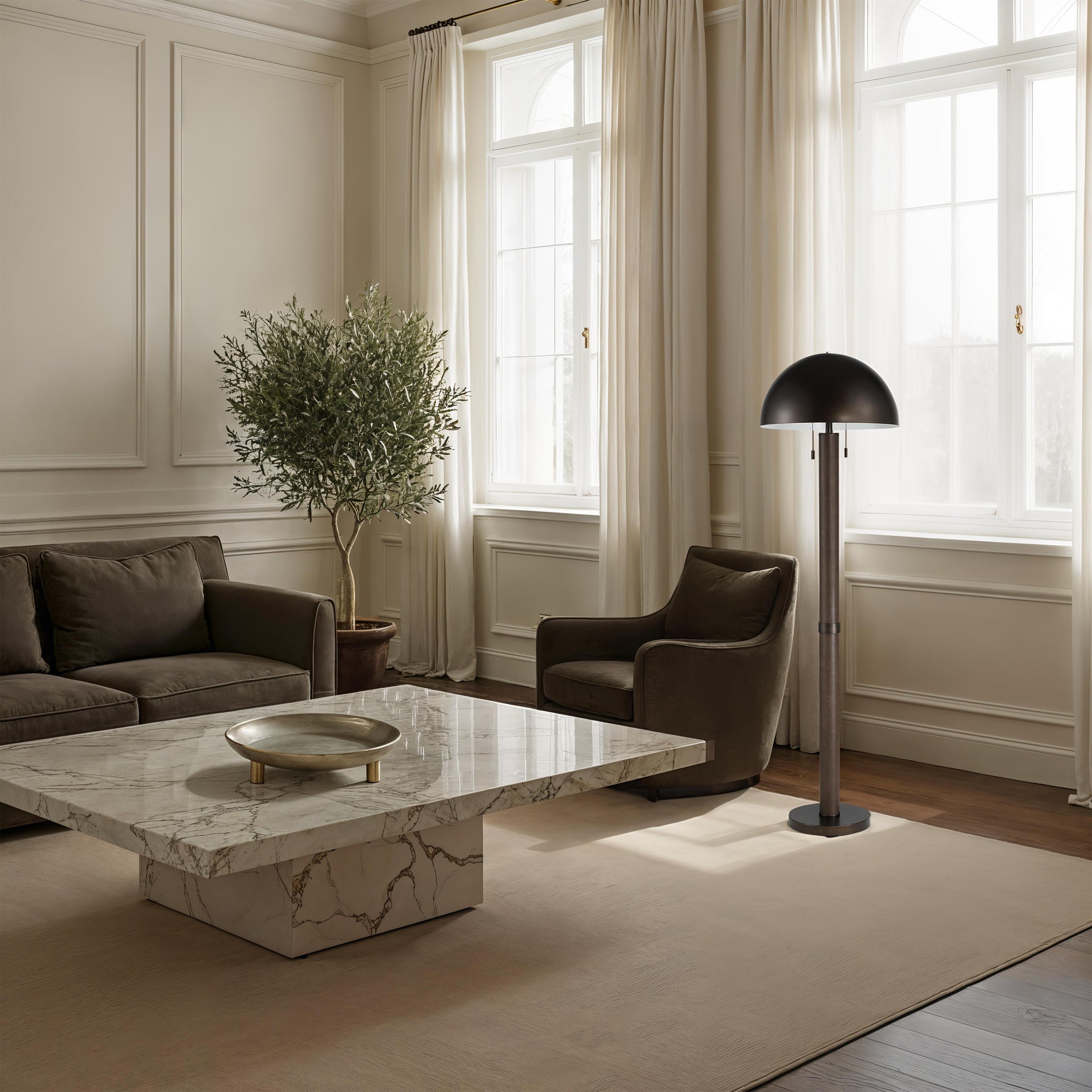 Incanta floor lamp placed in an elegant living room with a marble coffee table and greenery.