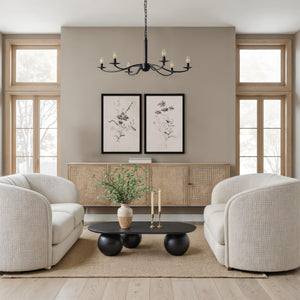 Adeline living room scene featuring two light beige sofas, black chandelier, and floral artwork.