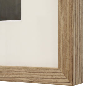 Henriette framed artwork corner detail with a light wood frame.