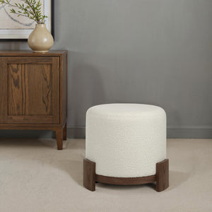 Chaves Ottoman by Renwil in a living room setting, cream fabric and dark wood base