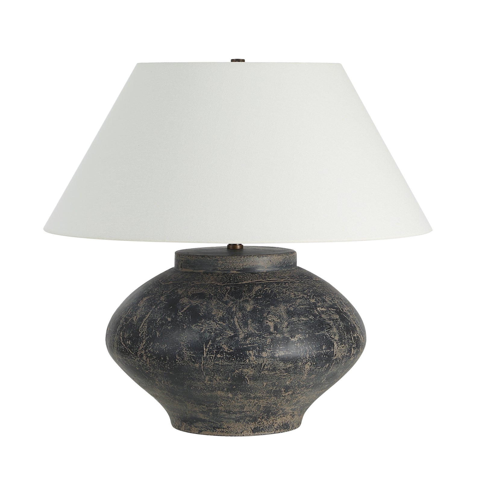 Patina table lamp with a round dark base and white fabric shade