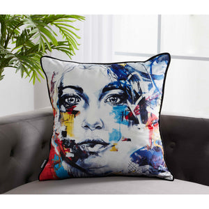 Tori Indoor Pillow displayed on a gray sofa, showcasing an artistic face print with vibrant colors.