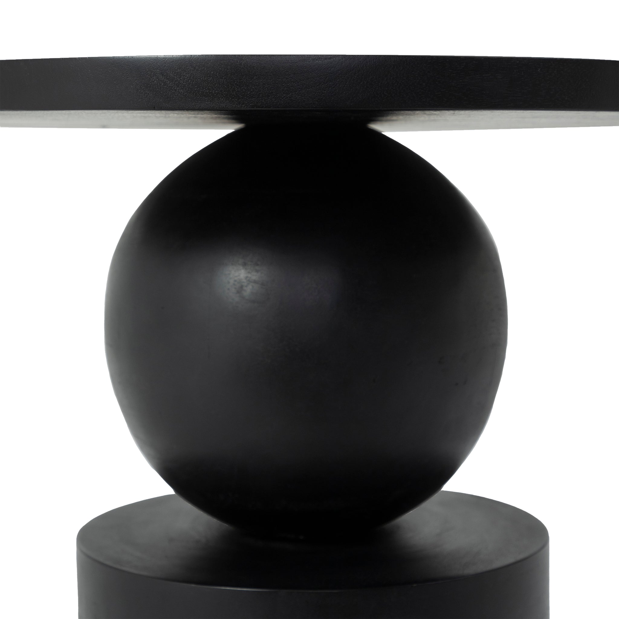 Close-up view of Paola side table's spherical base and round top in black.