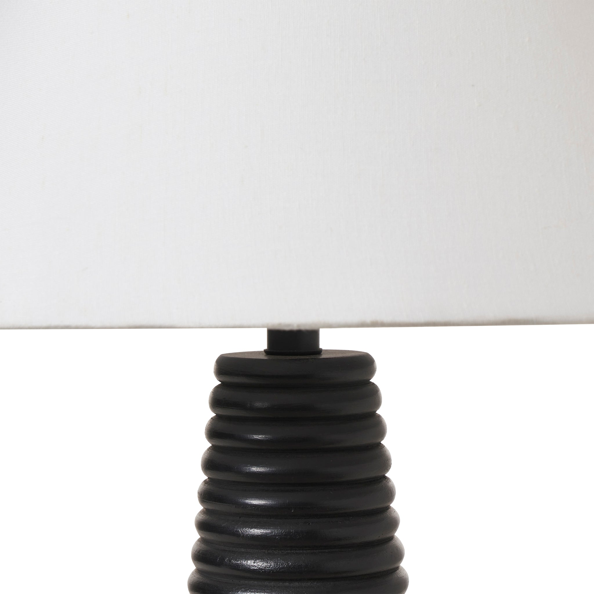 Kailua Table Lamp close-up of the black ribbed base and white shade.