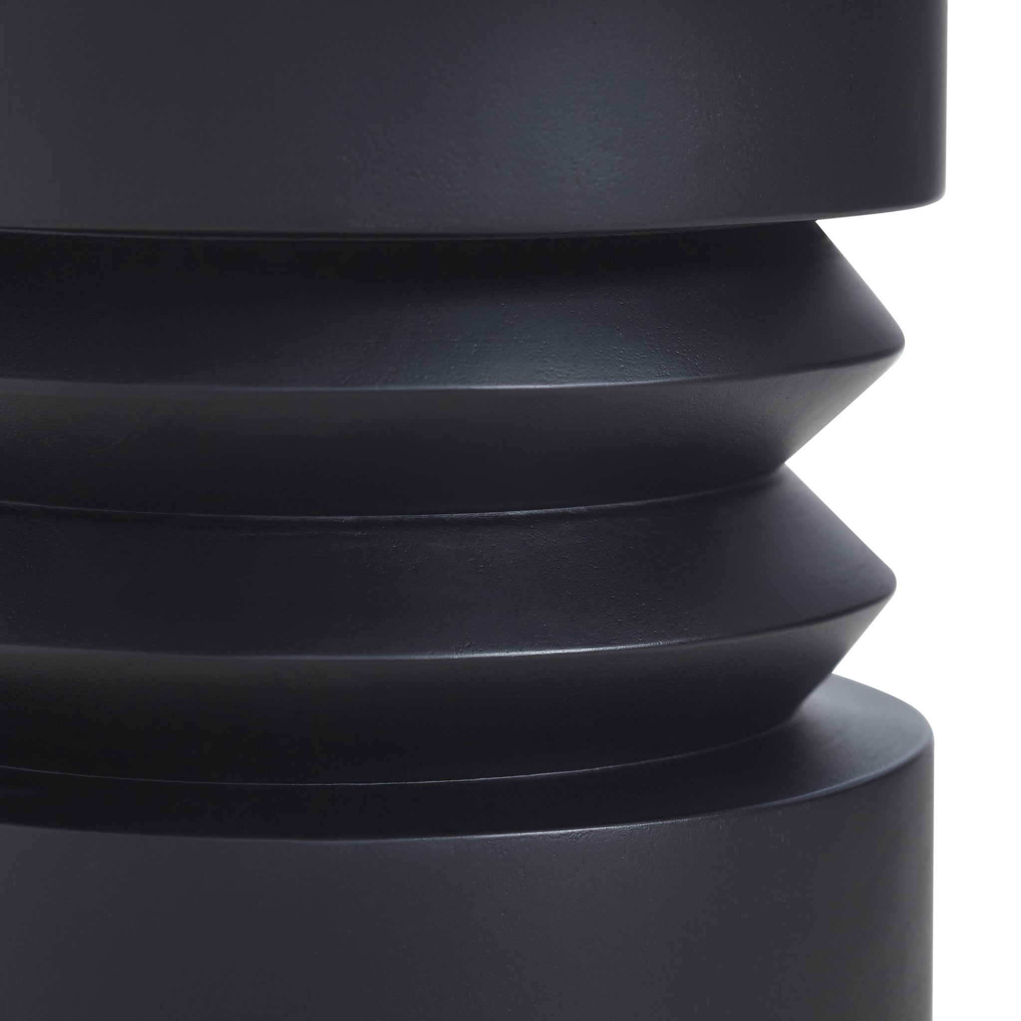 Talpa end table showing detailed view of the sculptural black base with layered design.