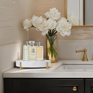Lingby vase on a bathroom counter with white flowers and perfume bottles.