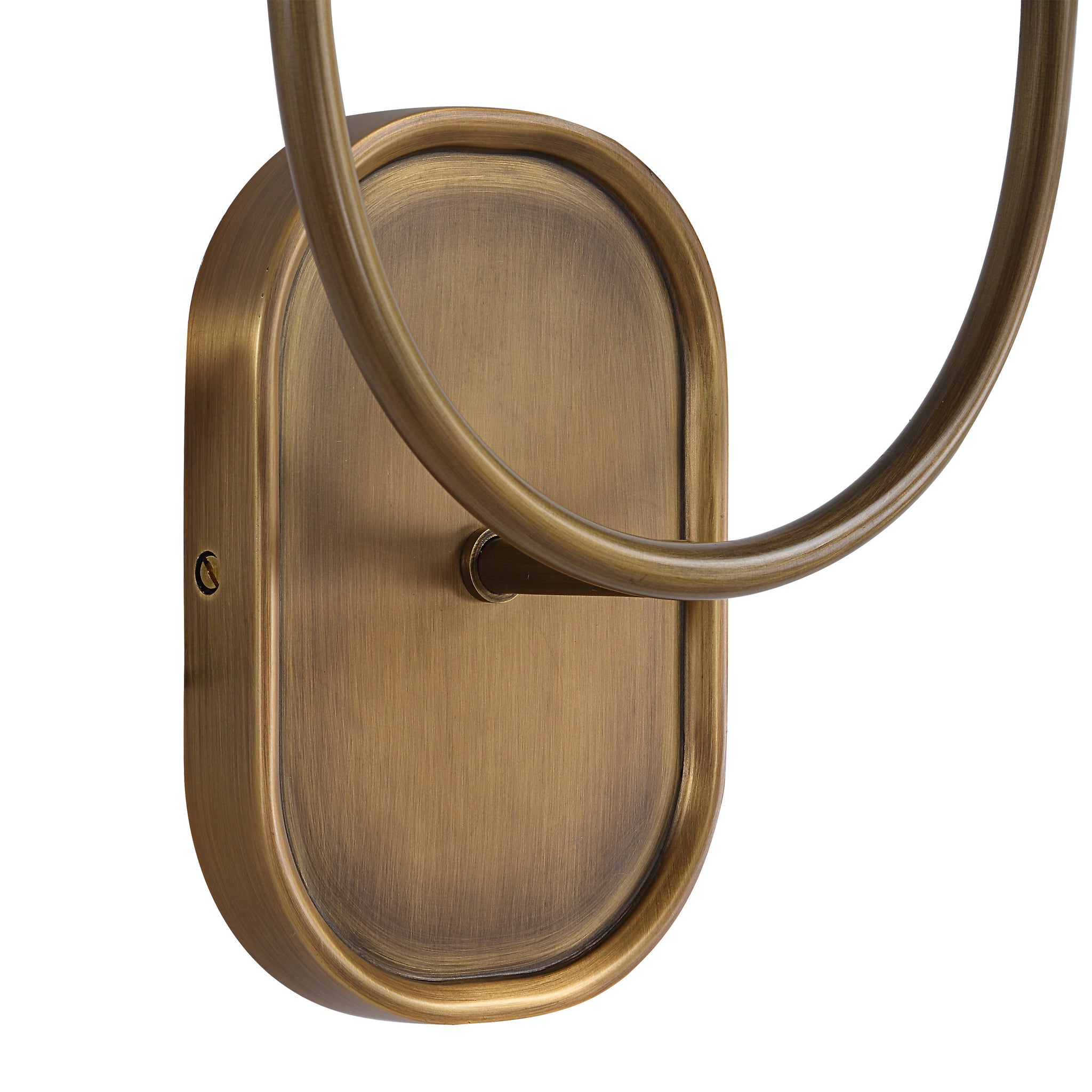 Close-up of Maddie wall sconce's antique brass backplate and curved arm