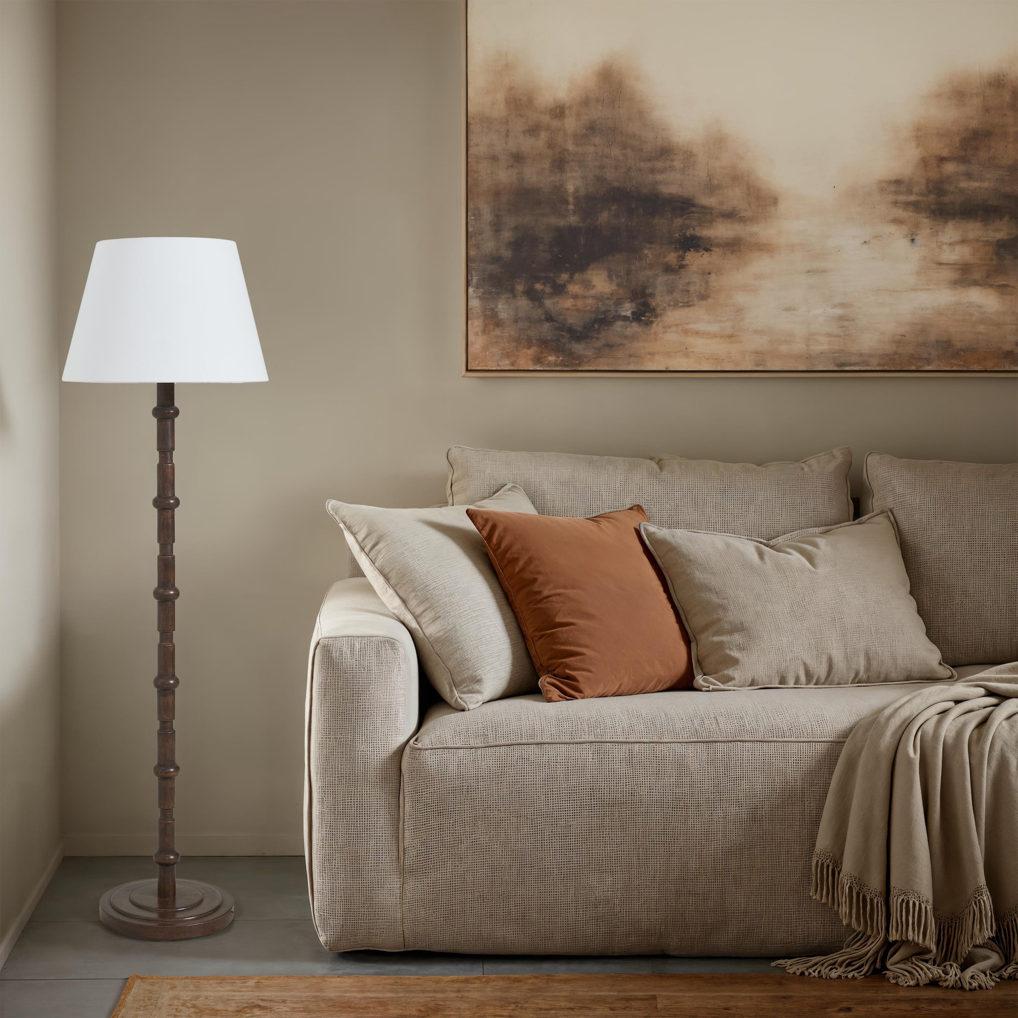 Odlam floor lamp next to a light-colored sofa adorned with pillows and a throw.
