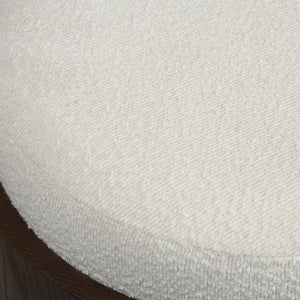 Capsula ottoman with a textured white fabric top and a wooden base, showcasing a close-up view of the surface.