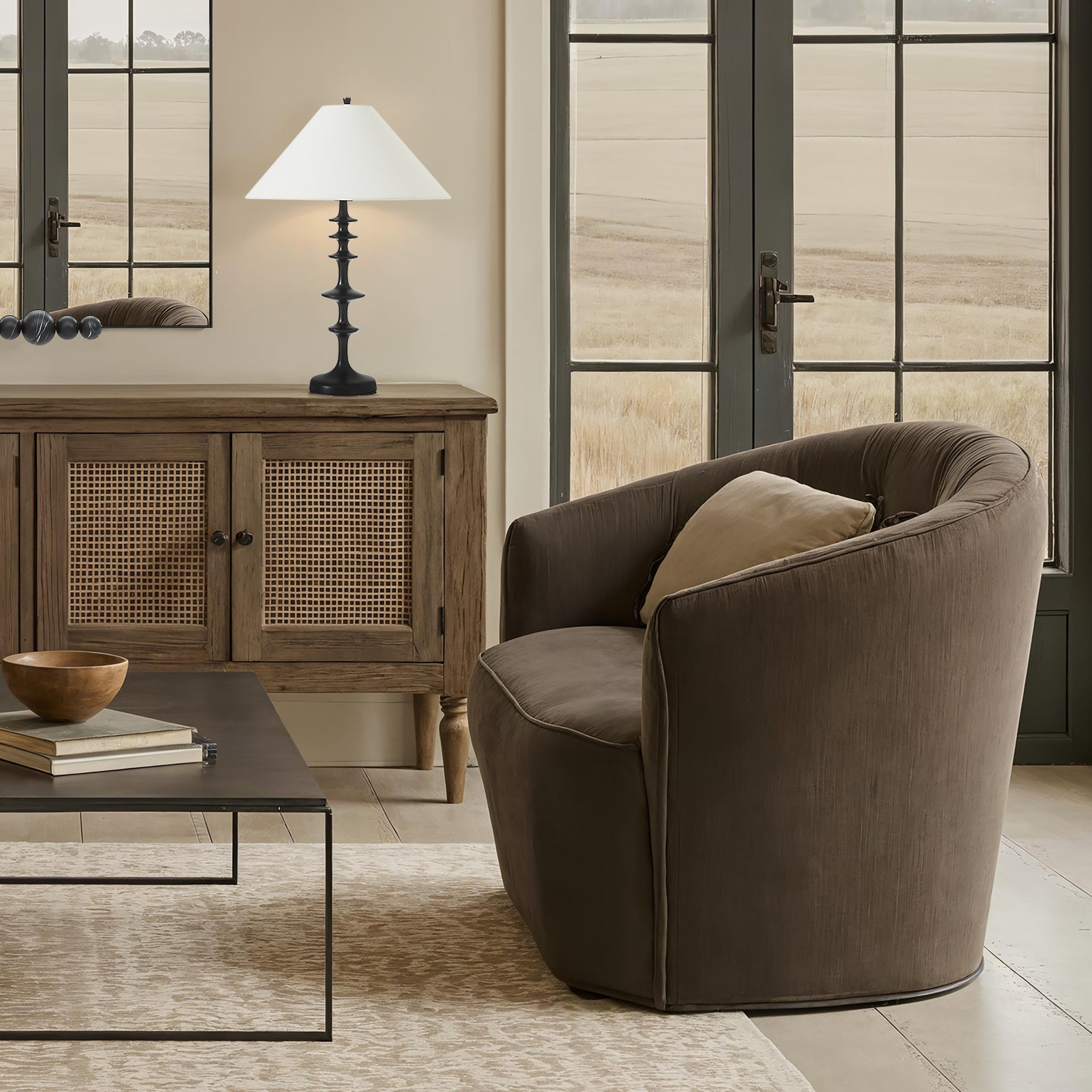 Petrus table lamp on a wooden console, complementing a cozy chair in a well-lit living room.