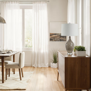 Vienne Table Lamp on a wooden sideboard in a bright dining room setting.