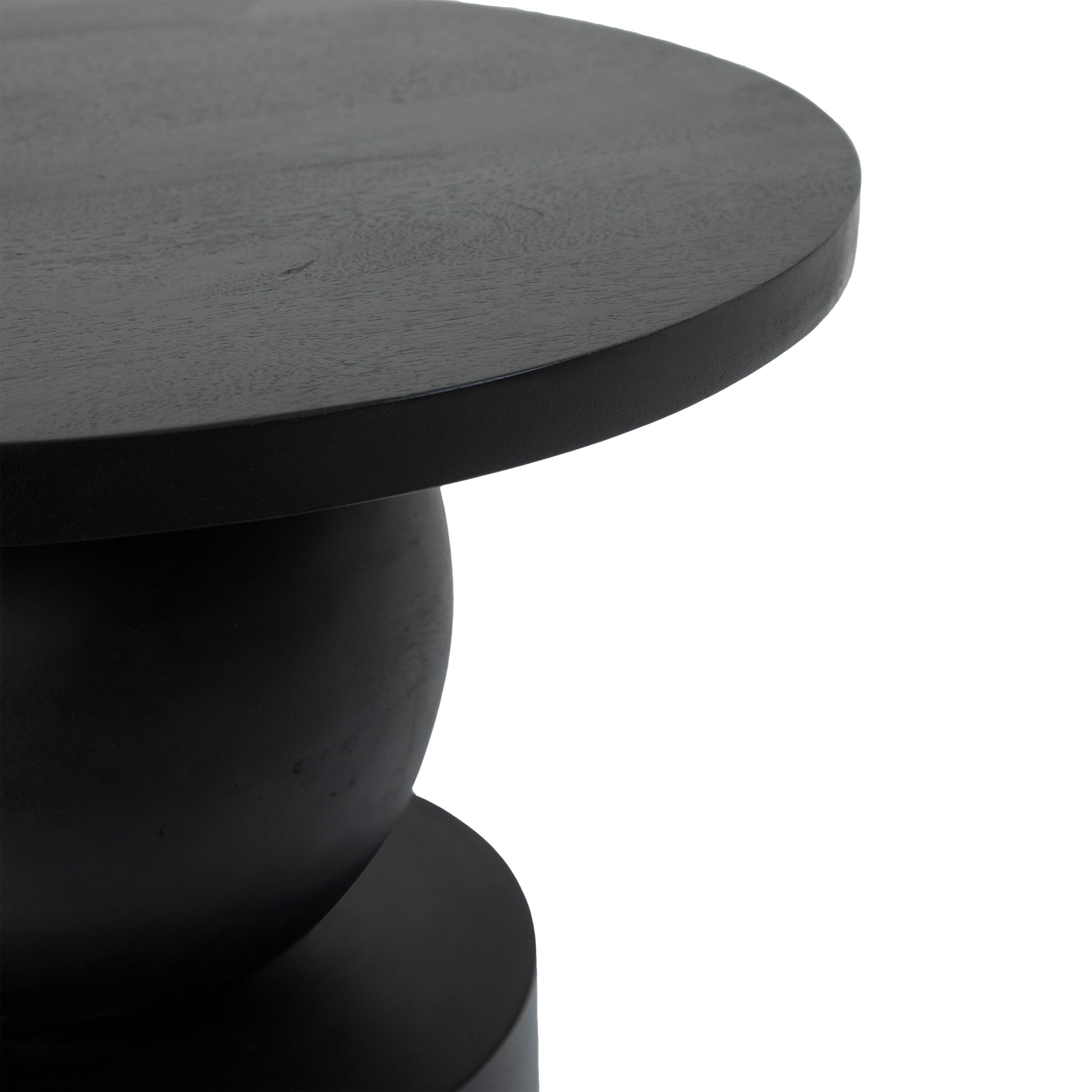 Paola Side Table featuring a round black top and a sculptural base.