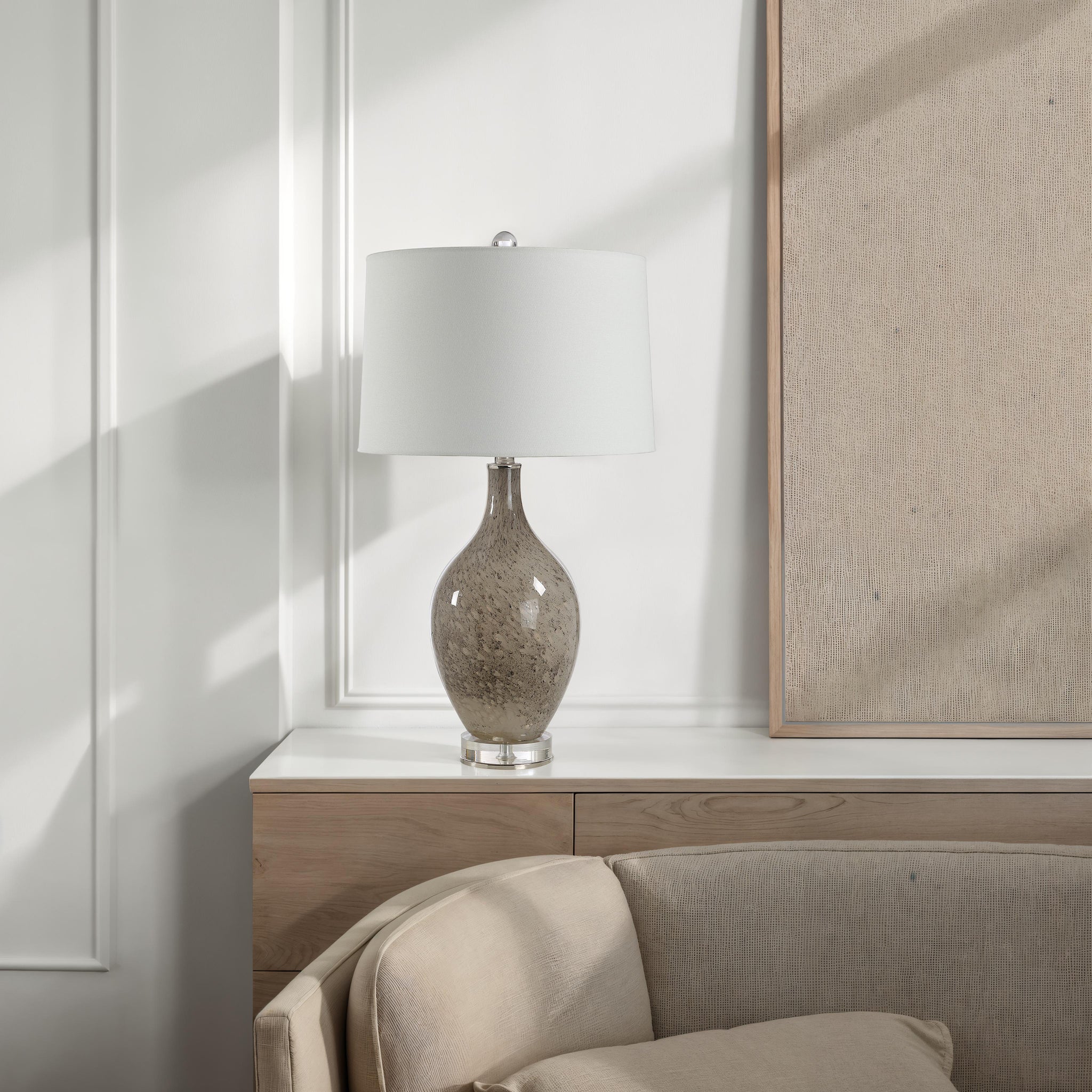 Vienne Table Lamp on a modern console table beside a beige sofa.