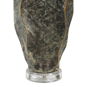 Close-up of Poppi table lamp's textured green ceramic base with a clear acrylic stand