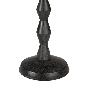 Close-up of Phyllis floor lamp's textured black base with geometric shapes