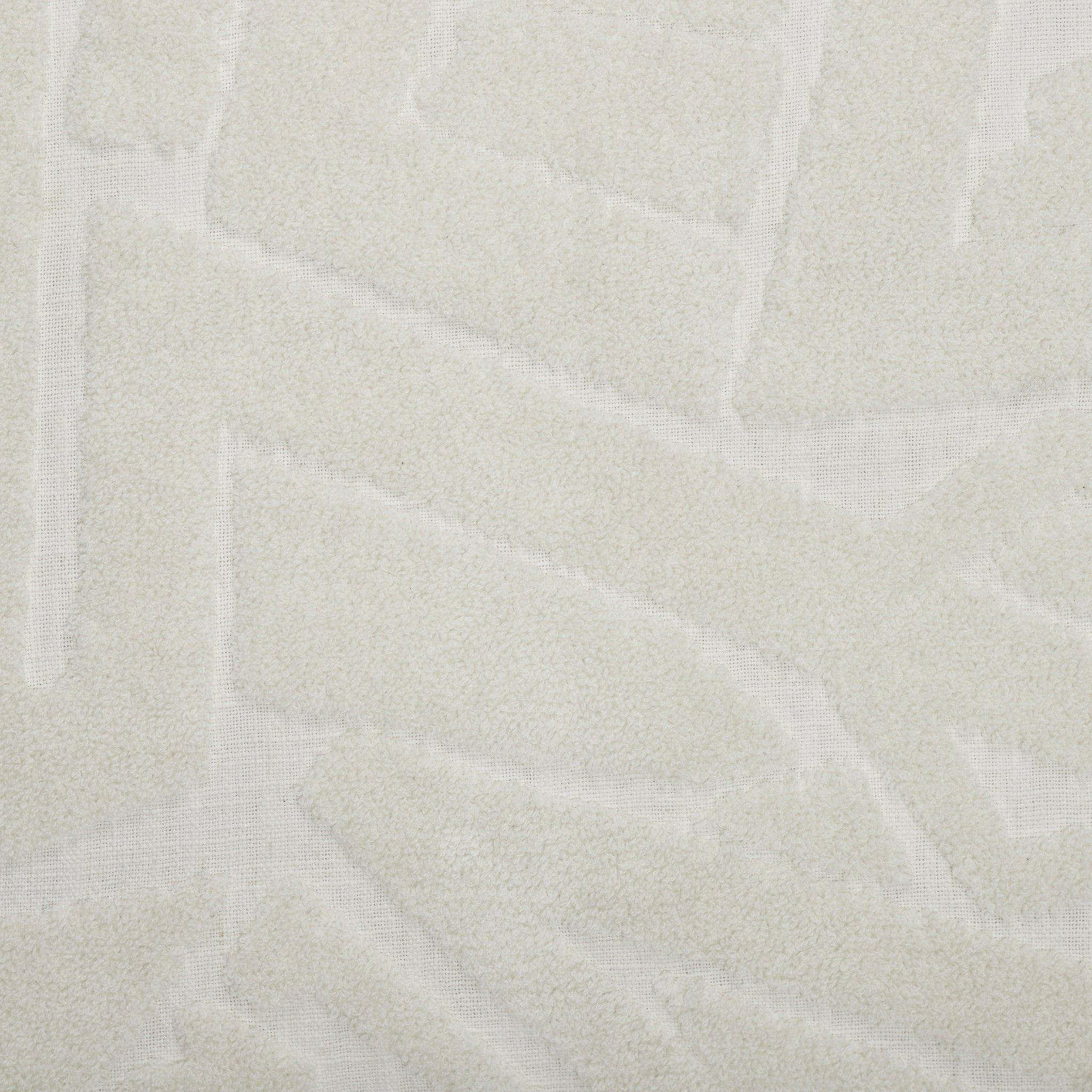 Close-up of Merano indoor pillow in white showcasing its textured design