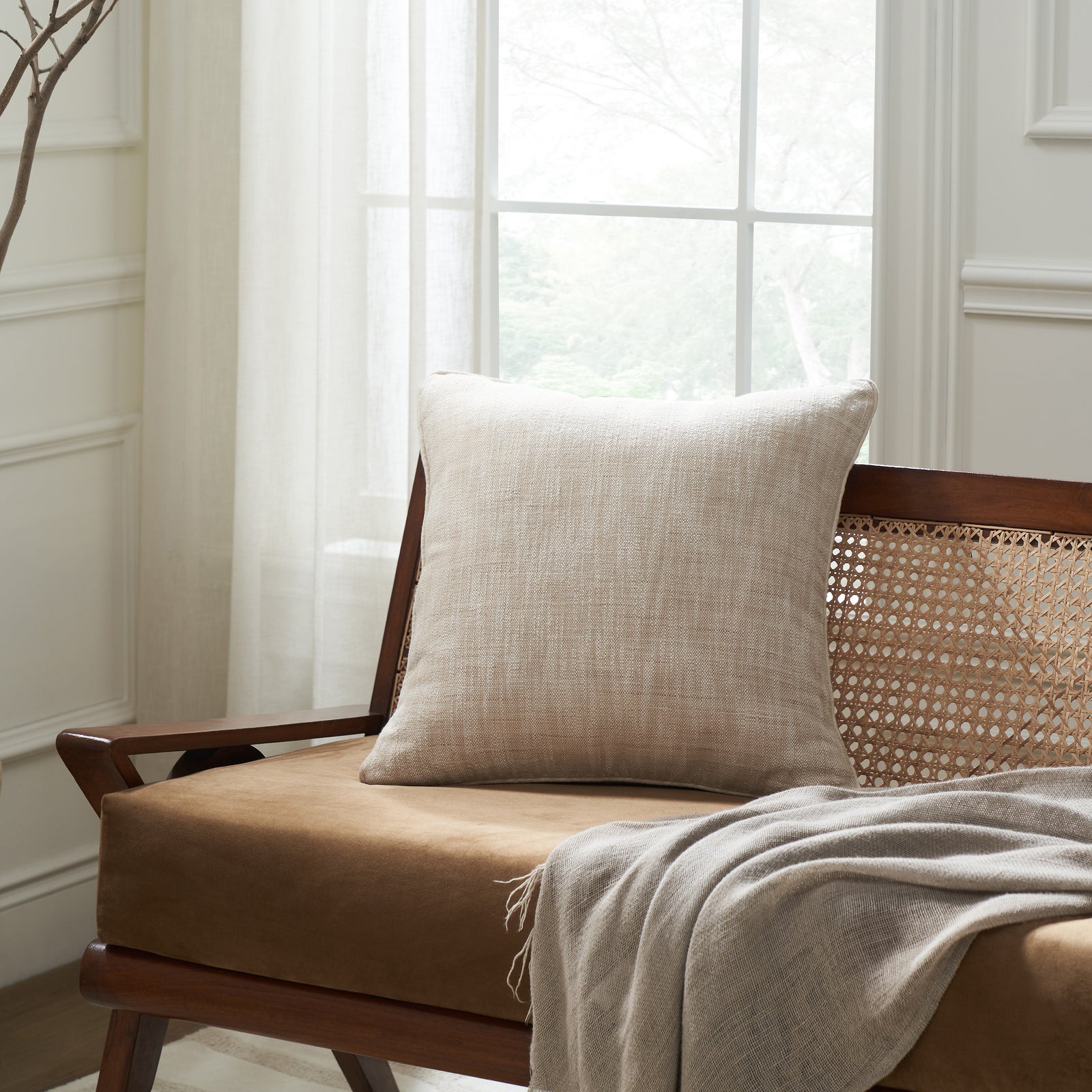 Amal indoor pillow in light beige with textured fabric surface.