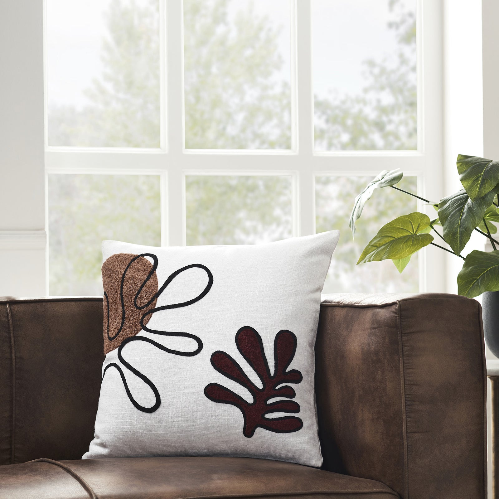 Erin Indoor Pillow with abstract brown and burgundy patterns on a white background