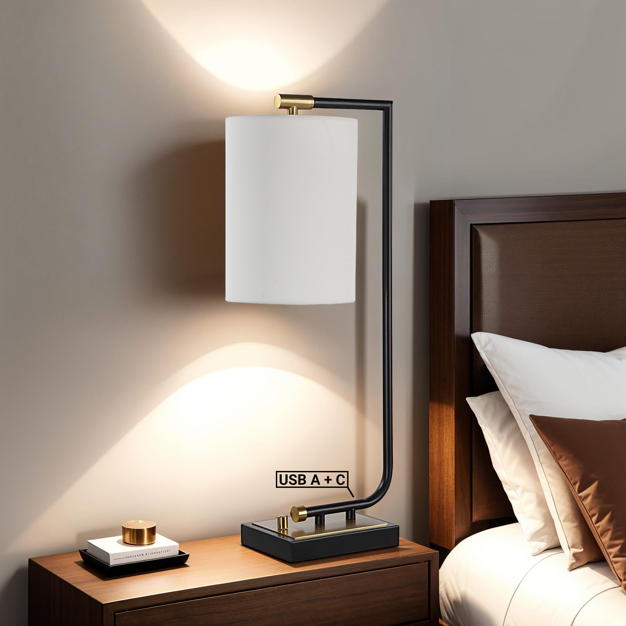 Perlato table lamp on a bedside table, illuminating a cozy bedroom with USB ports visible.