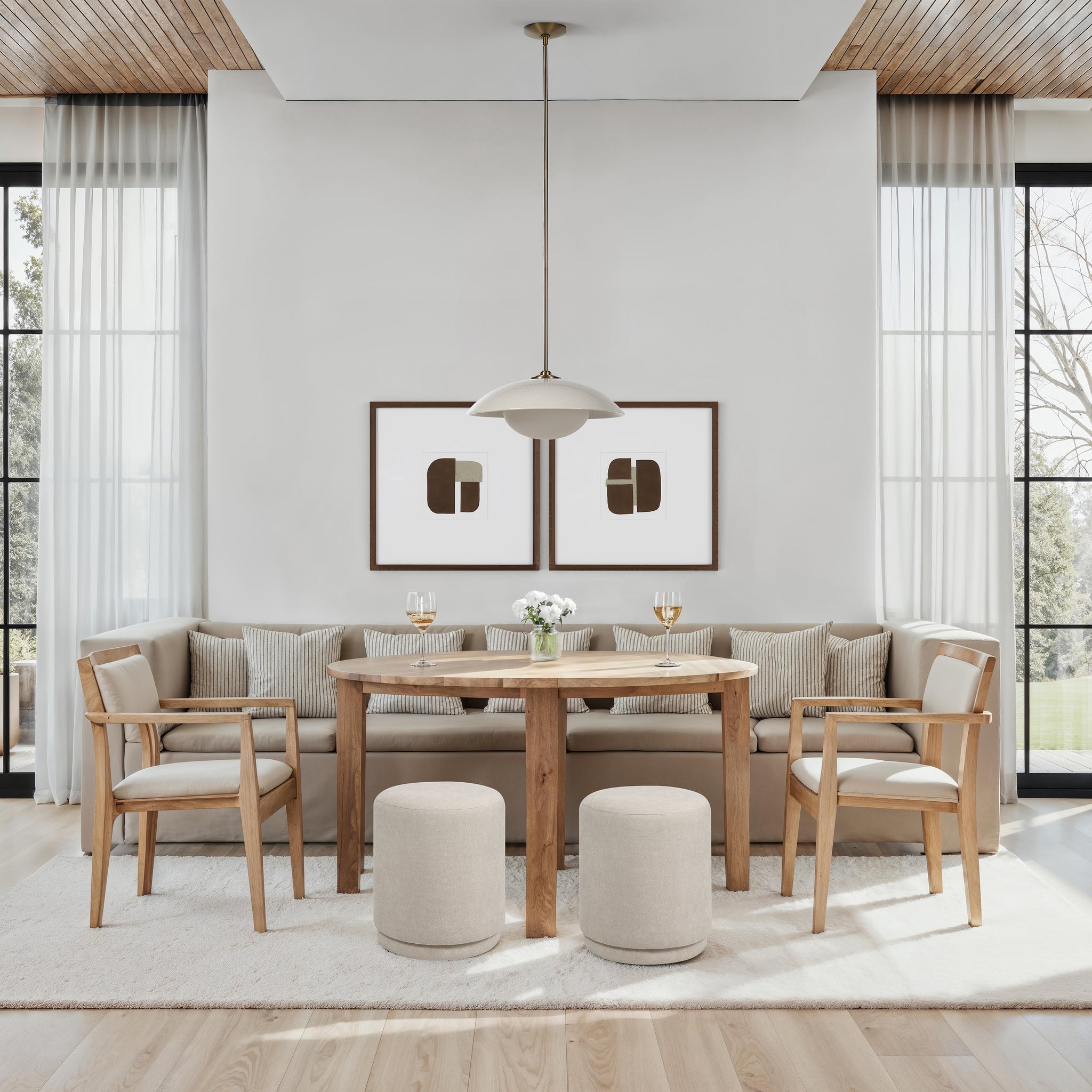 Dining area featuring two Persea stools in light beige, paired with a wooden table and chairs.