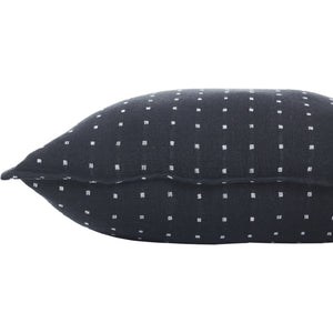 Side view of Brittany Indoor Pillow, displaying black fabric with white square design.