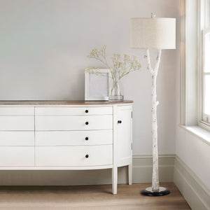 Criterion floor lamp positioned beside a white dresser with decorative flowers