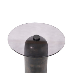 Close-up view of the Arta accent table's round smoky glass top and dark bronze base.