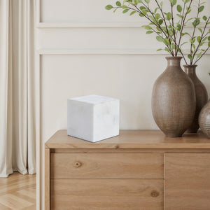Relica by Renwil white marble cube on a wooden dresser with vases
