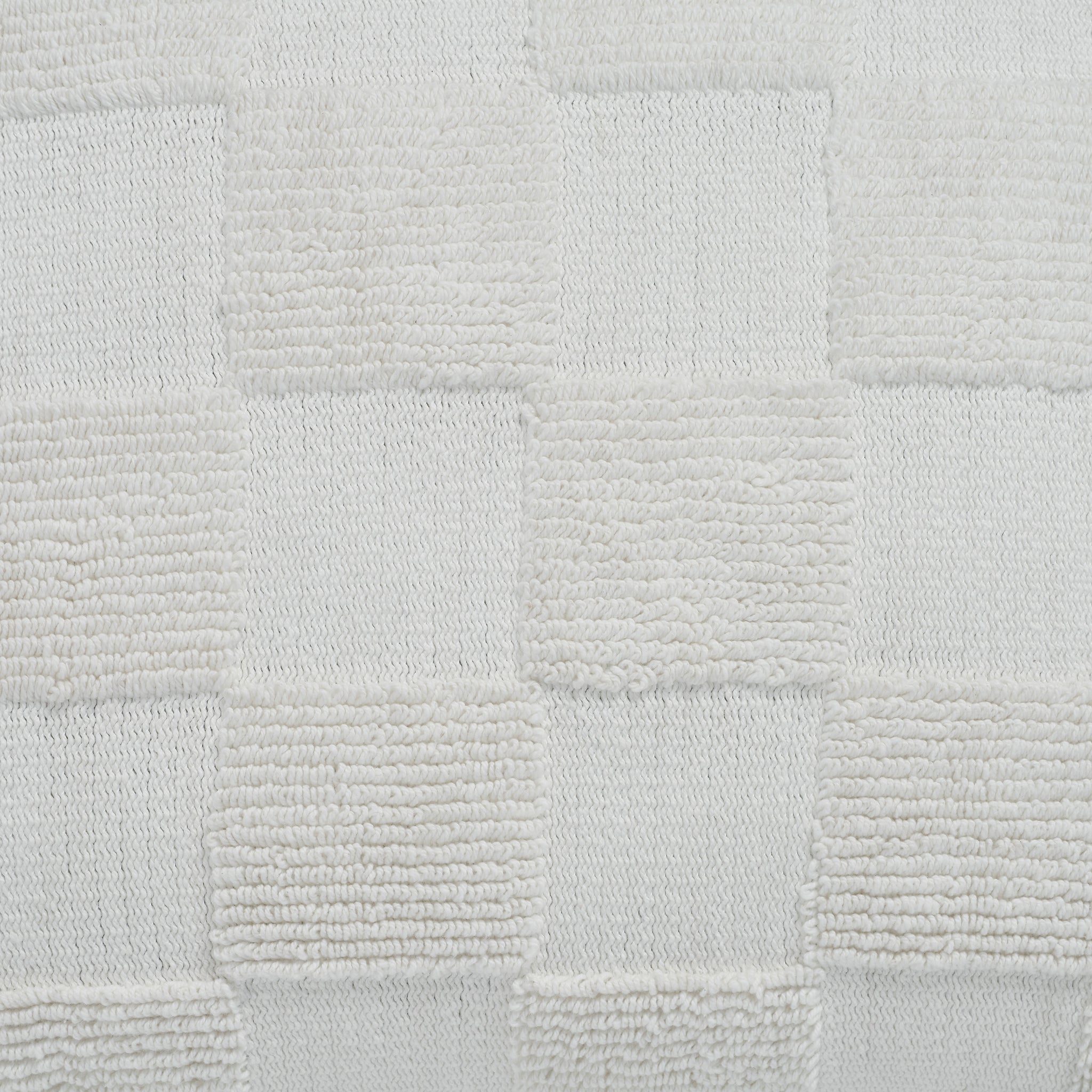 Close-up of Terrah Indoor Pillow showing white textured checkerboard detail