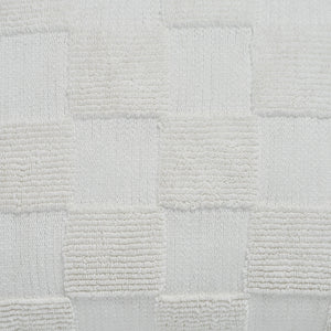 Close-up of Terrah Indoor Pillow showing white textured checkerboard detail