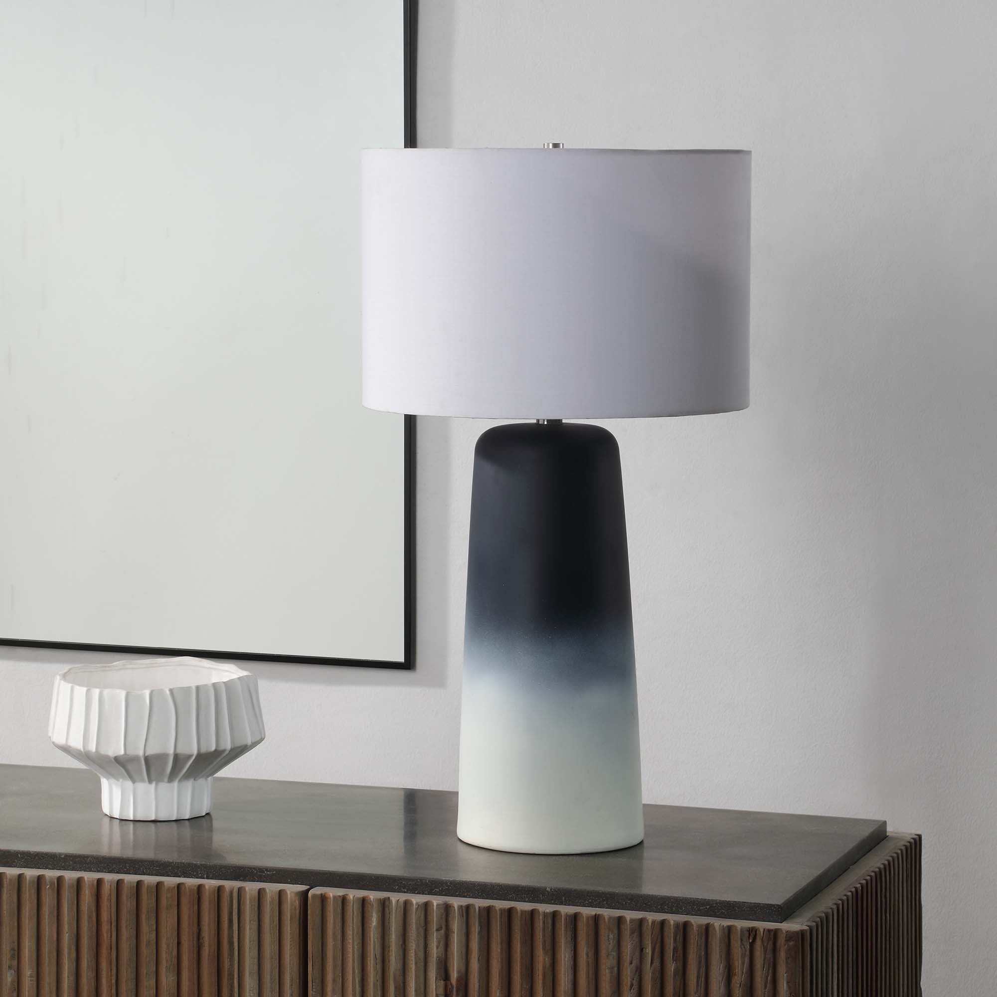 Monte Table Lamp on a console table, featuring a black and white gradient base and white shade.